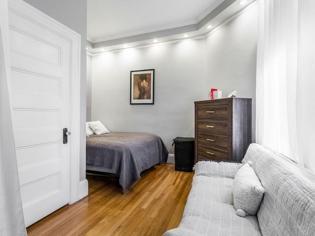 bedroom featuring light hardwood / wood-style flooring and ornamental molding