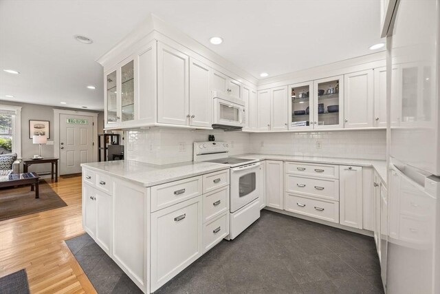 10 Seashore Park Dr Unit Gg, Provincetown, MA 02657 - kitchen with white appliances, recessed lighting, white cabinets, backsplash, and glass insert cabinets