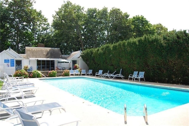 272 N Farm Dr Unit 272, Bristol, RI 02809 - community pool featuring a patio area, view of wooded area, and an outdoor structure