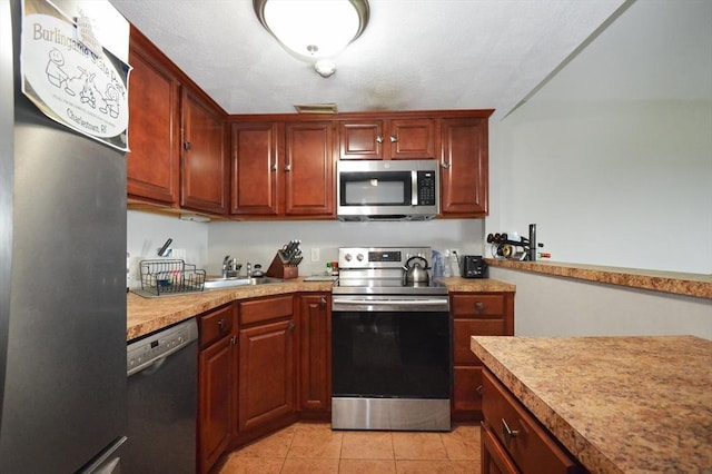 272 N Farm Dr Unit 272, Bristol, RI 02809 - kitchen with stainless steel appliances, a sink, light tile patterned floors, and light countertops