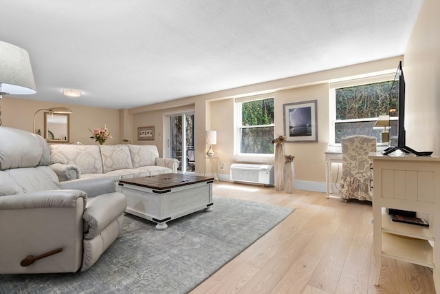 living area featuring hardwood / wood-style floors and baseboards