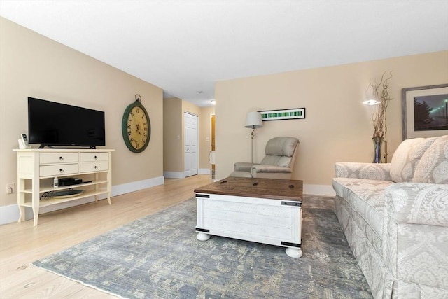 living area featuring wood finished floors and baseboards