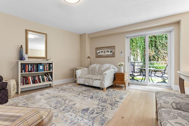 living room featuring wood finished floors and baseboards
