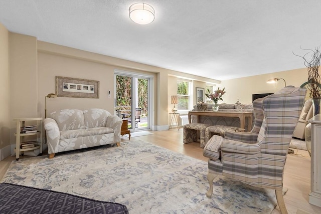 living area with light wood finished floors and baseboards
