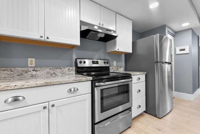 kitchen with appliances with stainless steel finishes, under cabinet range hood, light wood finished floors, white cabinetry, and recessed lighting