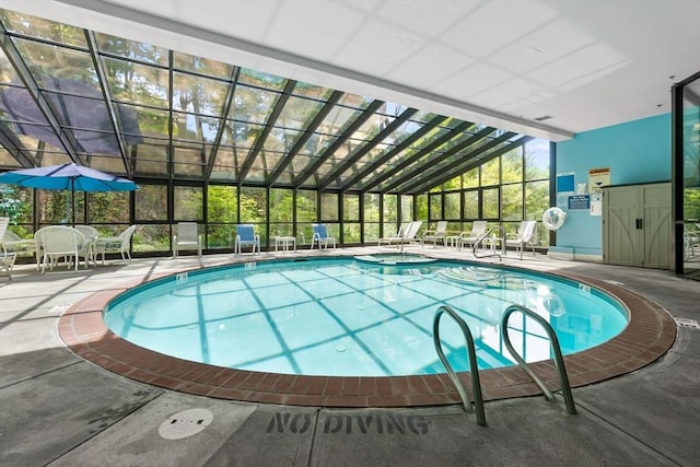 view of pool with a patio, a lanai, and a pool with connected hot tub