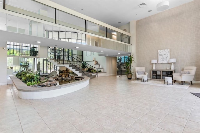 common area featuring a high ceiling and stairs