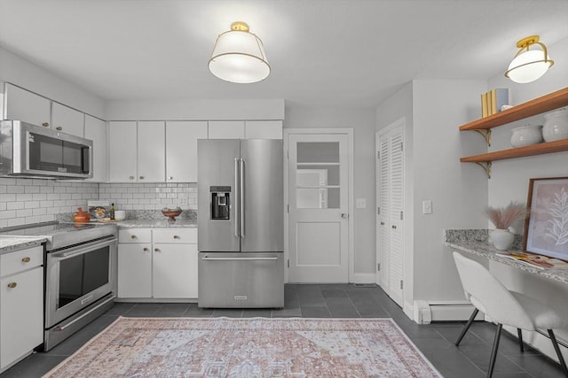 1705 Wampanoag Trl, Barrington, RI 02806 - kitchen featuring appliances with stainless steel finishes, dark tile patterned flooring, and white cabinetry