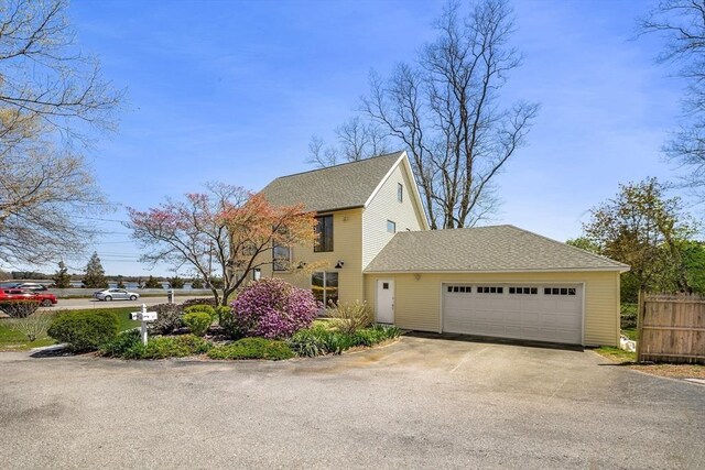 1705 Wampanoag Trl, Barrington, RI 02806 - view of front of property featuring driveway, an attached garage, and a shingled roof