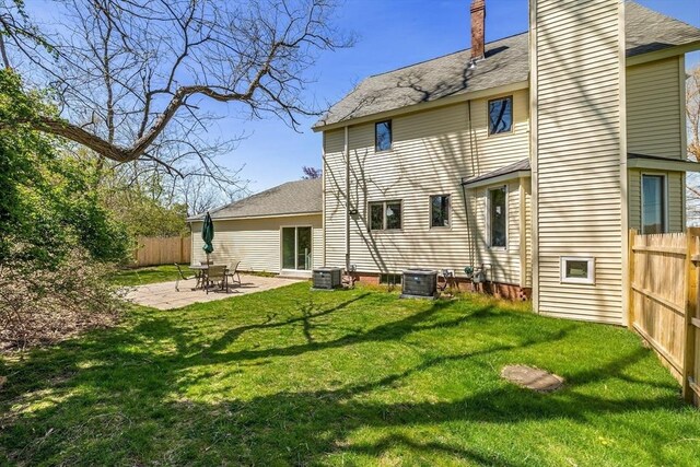 1705 Wampanoag Trl, Barrington, RI 02806 - back of house featuring a chimney, a shingled roof, a patio area, and central air condition unit