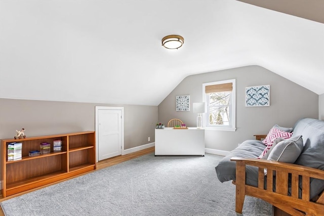 bedroom with baseboards, vaulted ceiling, and carpet flooring