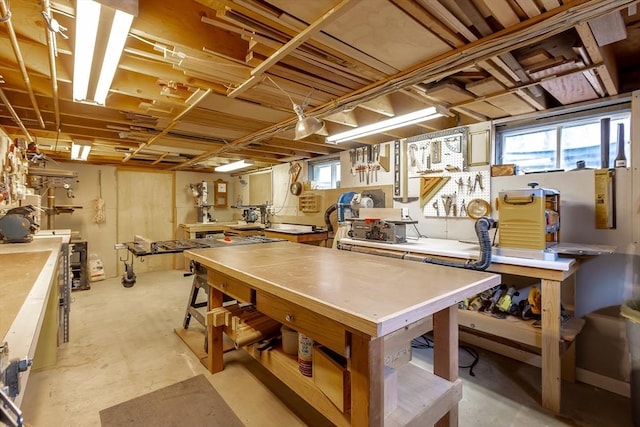 playroom with concrete floors and a workshop area