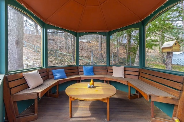 unfurnished sunroom with a sauna, plenty of natural light, and vaulted ceiling