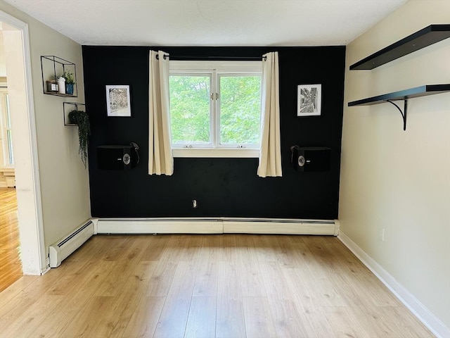 728 Stony Hill Rd, Wilbraham, MA 01095 - unfurnished bedroom featuring light wood-style floors and a baseboard heating unit