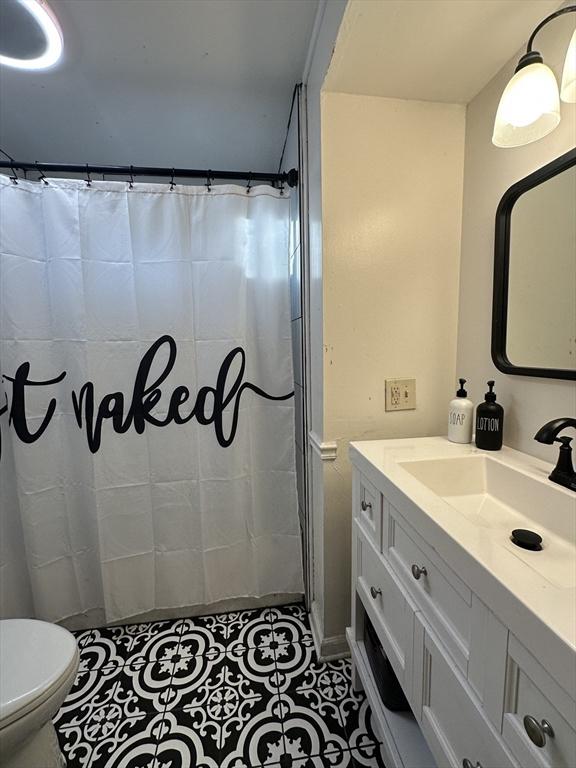 728 Stony Hill Rd, Wilbraham, MA 01095 - bathroom with vanity and a shower with shower curtain