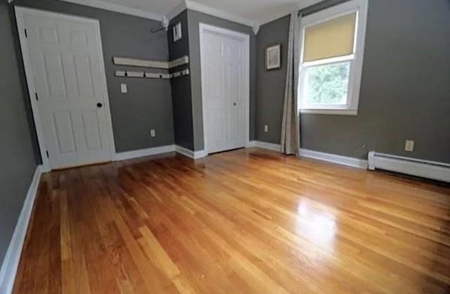 728 Stony Hill Rd, Wilbraham, MA 01095 - unfurnished bedroom featuring wood finished floors, crown molding, and baseboard heating