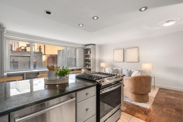 151 Tremont St Unit 8S, Boston, MA 02111 - kitchen with baseboards, recessed lighting, dark stone countertops, and stainless steel appliances