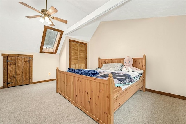 bedroom featuring light colored carpet, ceiling fan, lofted ceiling with beams, and a closet