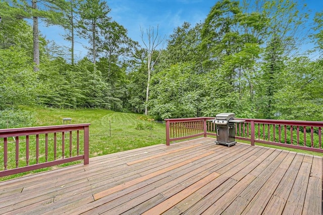 deck with a grill and a lawn