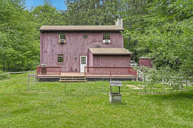 back of house with a wooden deck and a lawn