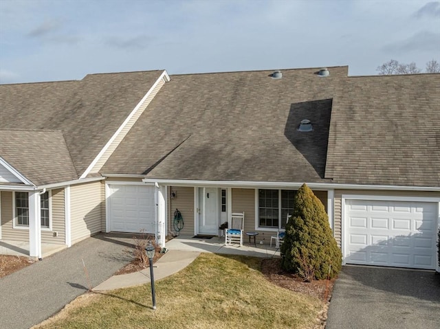 view of front of property with a garage and a front lawn