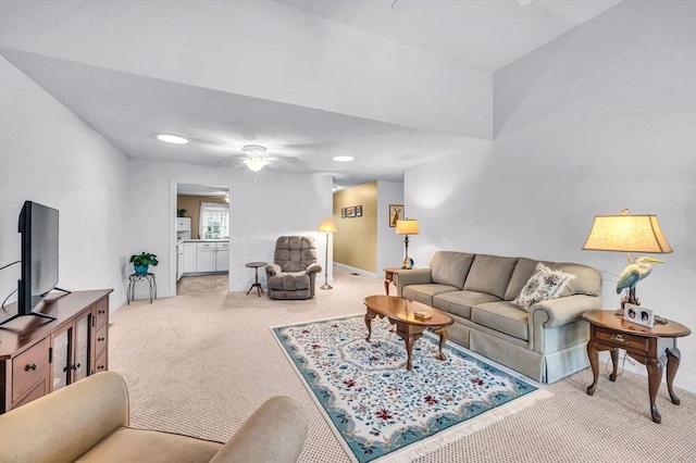 living room featuring ceiling fan and light colored carpet