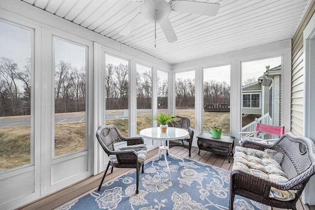 sunroom featuring ceiling fan