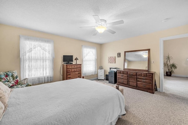 bedroom featuring carpet, a textured ceiling, and ceiling fan