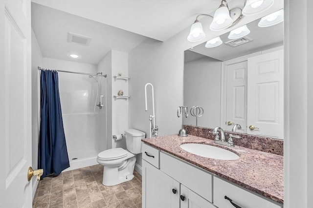 bathroom featuring toilet, vanity, and a shower with shower curtain