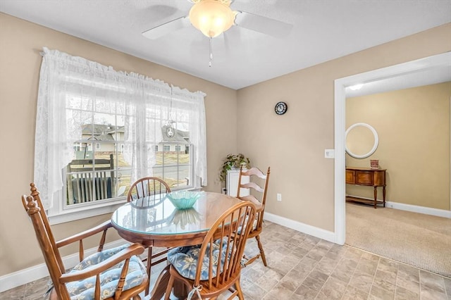 dining room with light carpet and ceiling fan