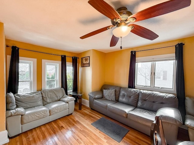 living room featuring ceiling fan, a healthy amount of sunlight, and light hardwood / wood-style floors