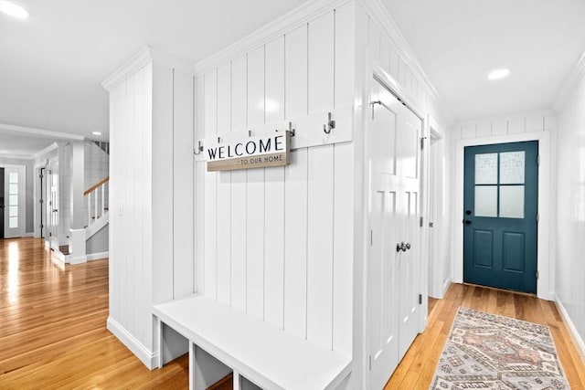mudroom with light wood-type flooring, crown molding, and recessed lighting