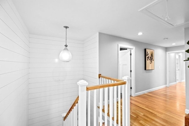 hallway with an upstairs landing, attic access, recessed lighting, light wood-type flooring, and baseboards