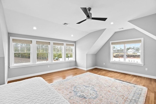 bedroom with vaulted ceiling, recessed lighting, baseboards, visible vents, and wood finished floors