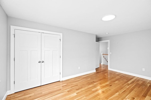 unfurnished bedroom featuring baseboards and light wood finished floors