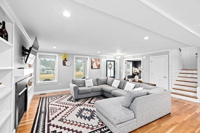living room featuring crown molding, stairway, recessed lighting, light wood-style floors, and a fireplace