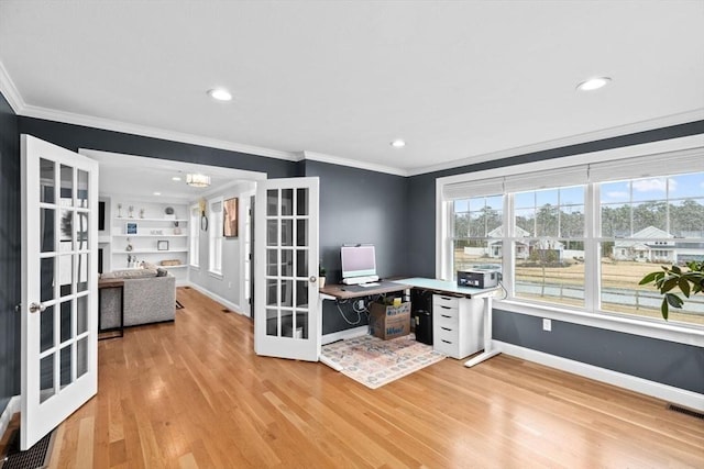 office space with light wood-style flooring, a wealth of natural light, visible vents, and french doors