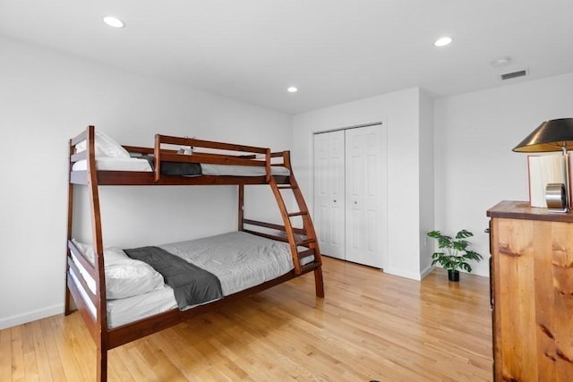 bedroom with visible vents, a closet, baseboards, light wood-type flooring, and recessed lighting