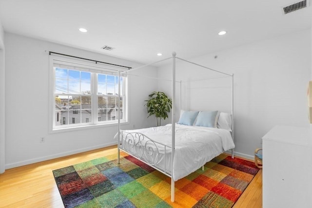 bedroom featuring recessed lighting, wood finished floors, and visible vents