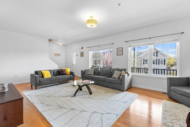 living area with light wood-style floors and baseboards