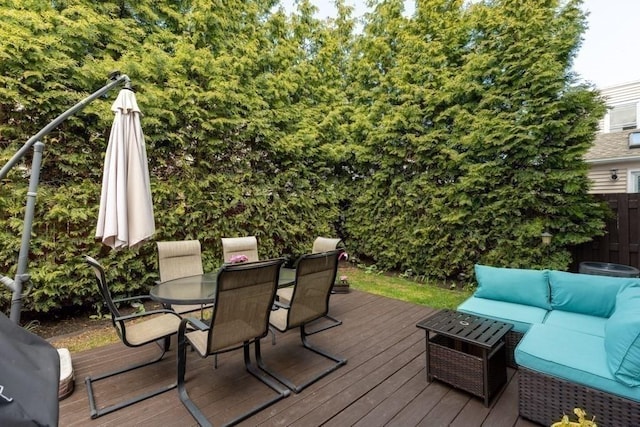 deck with fence, an outdoor living space, and outdoor dining area