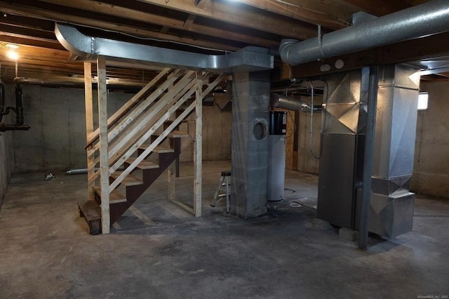 unfinished basement with stairs, heating unit, and water heater