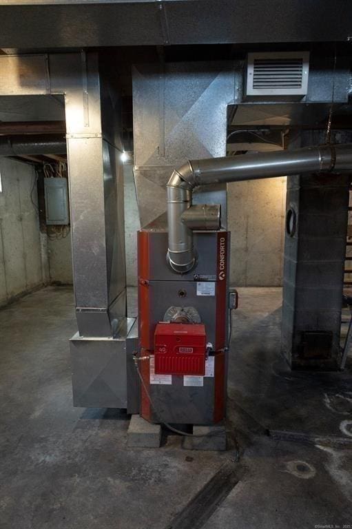 utility room featuring electric panel and visible vents