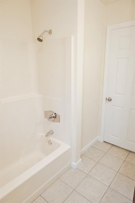 full bath featuring tile patterned flooring, shower / bathing tub combination, and baseboards