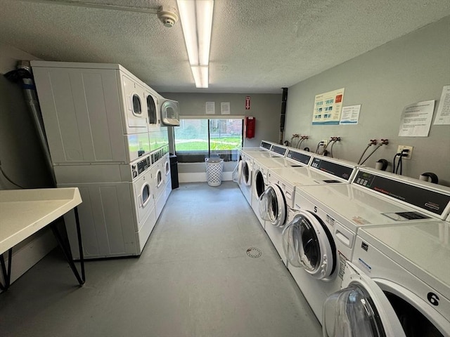 1186 Worcester Rd Unit 231, Framingham, MA 01702 - shared laundry room featuring stacked washer and clothes dryer, washing machine and clothes dryer, and a textured ceiling