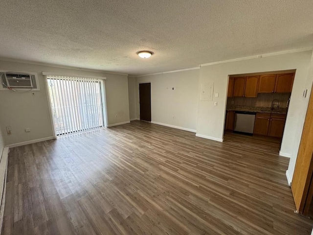 1186 Worcester Rd Unit 231, Framingham, MA 01702 - unfurnished living room featuring a wall unit AC, a textured ceiling, dark wood finished floors, crown molding, and baseboards