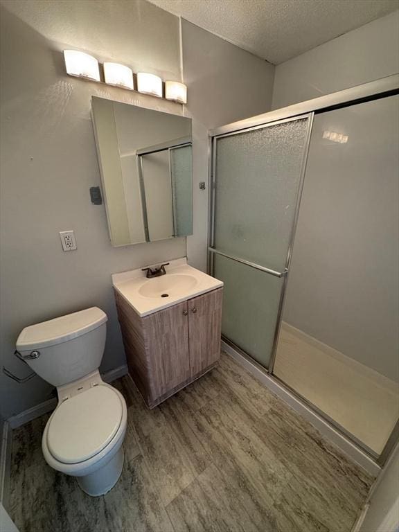 1186 Worcester Rd Unit 231, Framingham, MA 01702 - full bath featuring toilet, a textured ceiling, vanity, and a shower stall