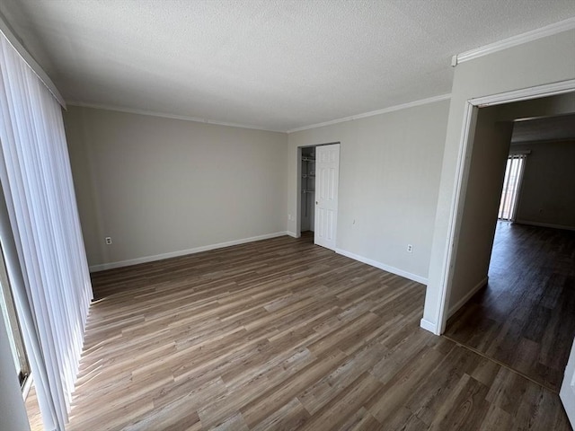 1186 Worcester Rd Unit 231, Framingham, MA 01702 - unfurnished room with wood finished floors, a textured ceiling, ornamental molding, and baseboards