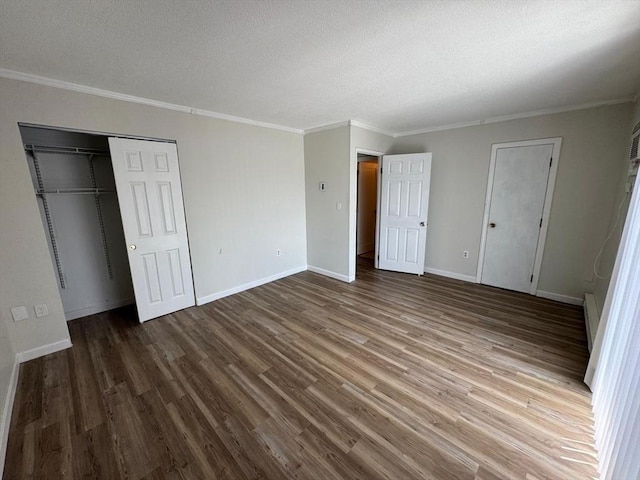 1186 Worcester Rd Unit 231, Framingham, MA 01702 - unfurnished bedroom featuring a textured ceiling, wood finished floors, crown molding, baseboards, and a closet