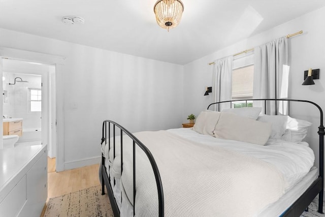 633 Lagrange St, Boston, MA 02132 - bedroom with light wood finished floors, connected bathroom, and baseboards
